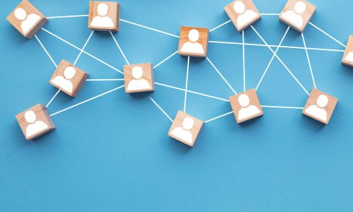 Wooden blocks connected together on a blue background. Teamwork concept Wooden blocks connected together on a blue background. Teamwork concept